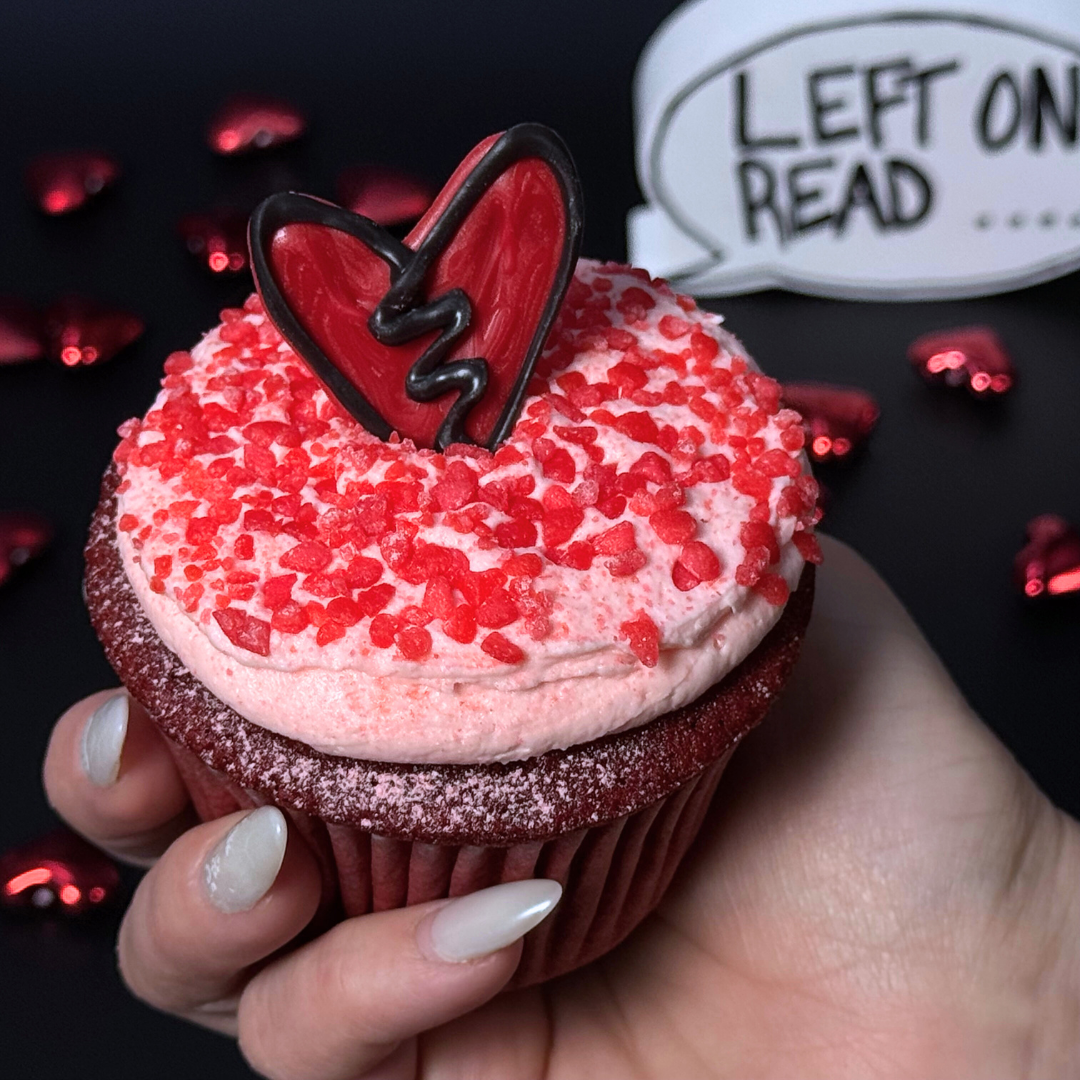 Jumbo cupcake hand view, red velvet, left on read, bakery in abilene texas, cupcake delivery.